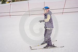 Woman learning to ski. Young woman skiing on a snowy road in the mountains