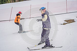 Woman learning to ski. Young woman skiing on a snowy road in the mountains