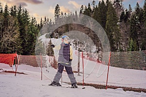 Woman learning to ski. Young woman skiing on a snowy road in the mountains