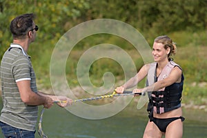 Woman learning to waterski with instructor