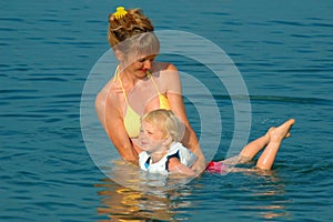 Woman learns child to float