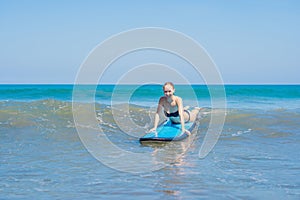 A woman learns to surf on the foam. Bali Indonesia