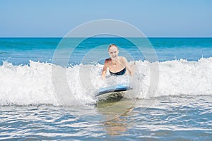 A woman learns to surf on the foam. Bali Indonesia