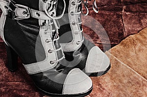 Woman leather boots on seude background