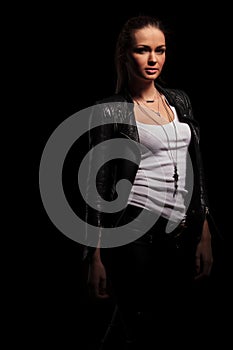 woman in leather jacket and undershirt standing