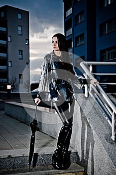 Woman In Leather And Raincoat
