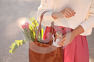 Woman with leather shopper bag outdoors, closeup