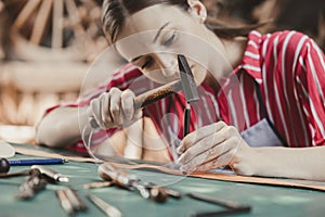 woman leather tailor artist handcraft working at own workshop small studio made by order masterwork piece photo