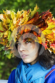 Woman with leaves on head look suspiciously