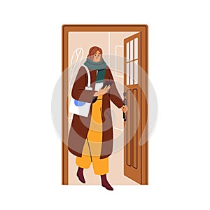 Woman leaving home, opening house door, exiting outside. Person in coat, holding mobile phone in hand, going out to work