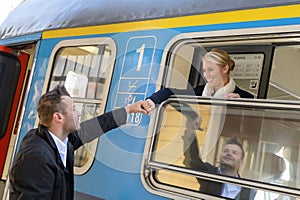 Woman leaving with train man holding hand