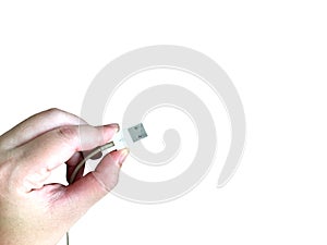 Woman hand holding USB cable for connect with electronic part isolated on white background.