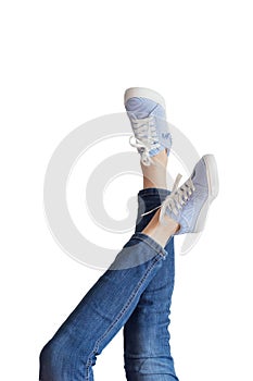 Woman legs in a blue jeans on white background isolated