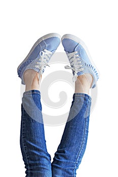 Woman legs in a blue jeans on white background isolated