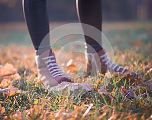 Woman legs boots in autumn nature