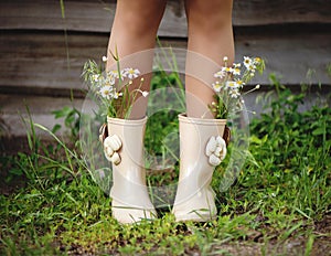 Woman legs with flowers in boots.