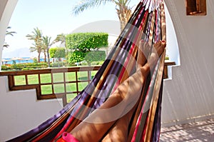 Woman legs in hammock - landscape