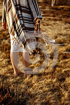 Woman legs in native indian american boho dress walking in windy