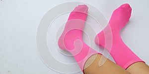 Woman legs in new pink socks isolate  on white background