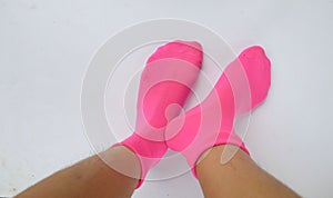 Woman legs in new pink socks isolate  on white background