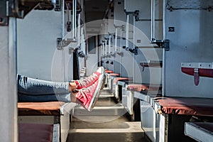Woman legs in red tennis shoes in a vintage empty train car. Fem