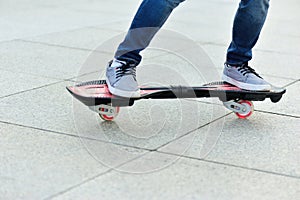 Woman legs riding on ripstick