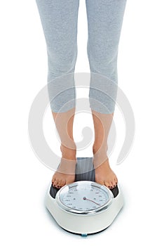 Woman, legs and scale in studio for weight loss, healthcare and wellness for vitality. Female person, diet and check