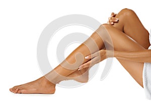 Woman legs, skin care and grooming in studio for wellness, fresh and hygiene against a white background. Beauty, leg and