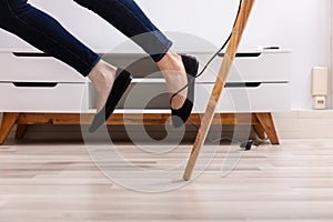 Woman Legs Stumbling With An Electrical Cord
