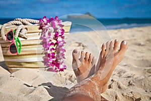 Woman legs on the sunset beach