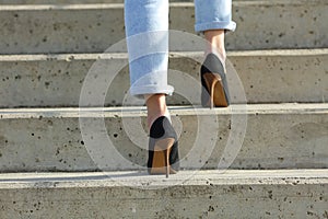 Woman legs wearing high heels walking up stairs