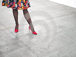 Woman legs wearing red high heels shoes