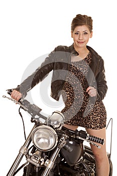 Woman leopard dress jacket stand on motorcycle look