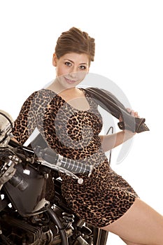 woman leopard dress motorcycle sit sit smile jacket over shoulder