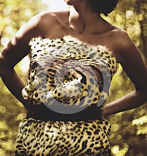 Woman in leopard fur print clothes wild jungle forest