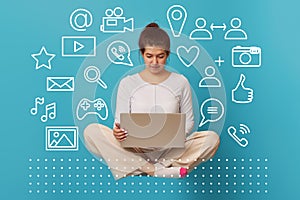 Woman levitates in lotus position with laptop.