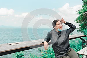Woman (LGBTQ) posing at sea viewpoint with happy