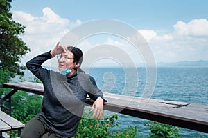 Woman (LGBTQ) posing at sea viewpoint with happy