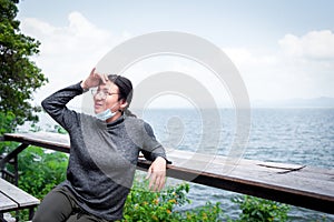 Woman (LGBTQ) posing at sea viewpoint with happy