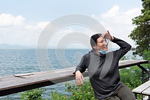 Woman (LGBTQ) posing at sea viewpoint with happy
