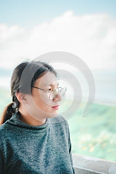 Woman (LGBTQ) posing at sea viewpoint with happy