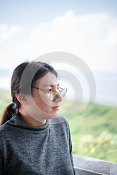 Woman (LGBTQ) posing at sea viewpoint with happy