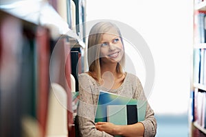 Woman, library and book, thinking about story for education and knowledge with smile on campus. College student with