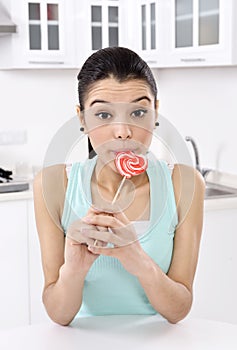 Woman licking sweet sugar candy
