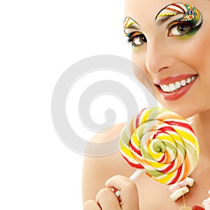 Woman licks candy with beautiful make-up