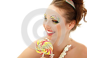 Woman licks candy with beautiful make-up isolated on white