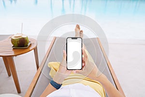 Woman lie down on pool bed touching phone white screen