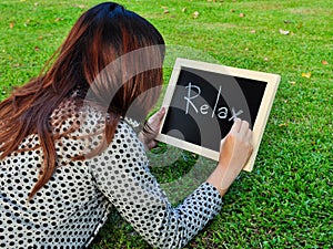 Woman lie down and write word on the blackboard