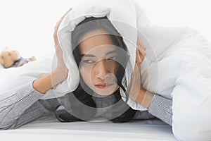 Woman lie prone and put blanket cover head