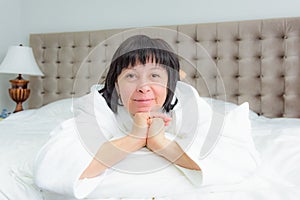 Woman lies in bed